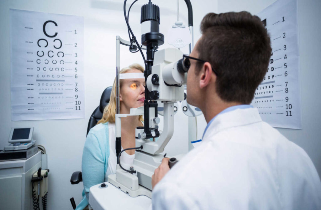An optometrist examining a patient's eyes during a diabetic eye exam