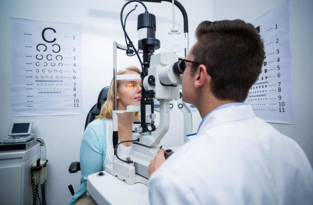 A woman in her forties getting her eyes checked by an optometrist.