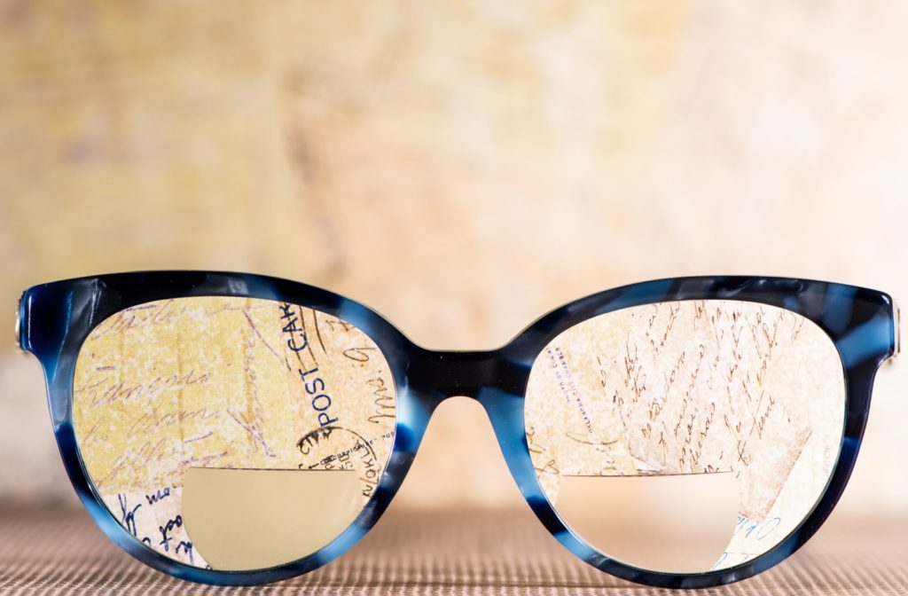 A closeup of bifocal eyeglasses showcasing reading and distance visual powers.