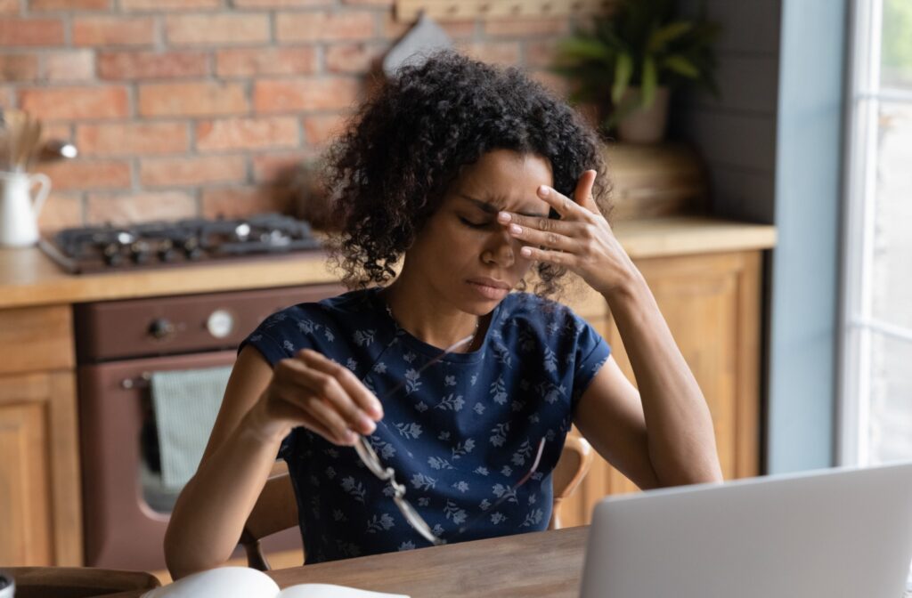 A person holding there hands to their eyes, experiencing the symptoms of dry eye