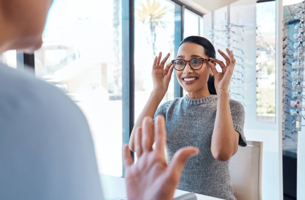 A woman at the optometrist's office trying on a pair of Nuance Audio glasses with her correct prescription.
